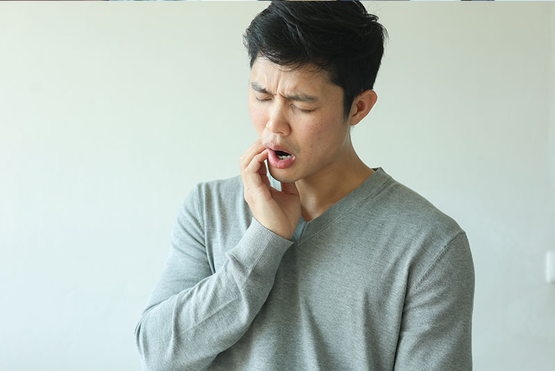 close up of person having mouth pain