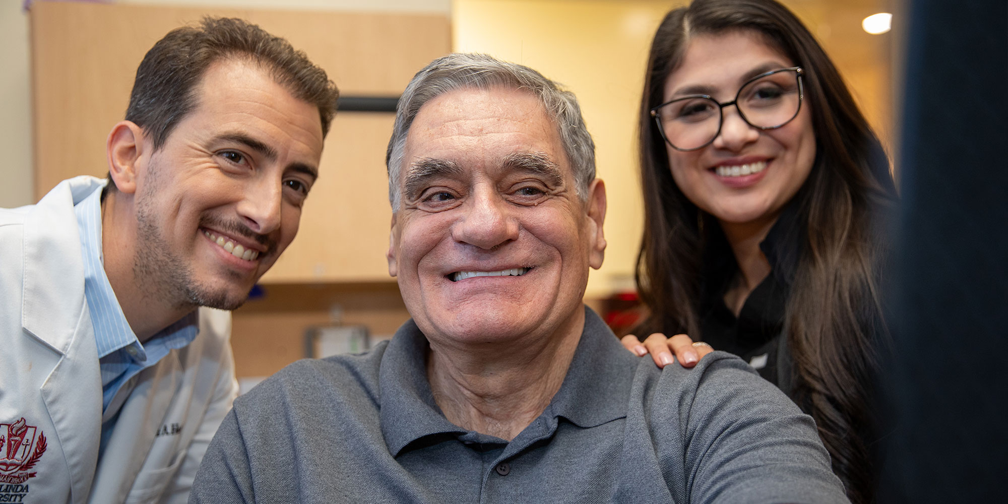 patient and doctor and staff smiling brightly after all on x treatment