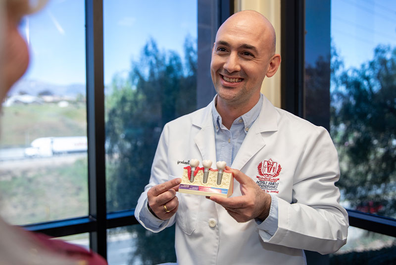 doctor showcasing dental implants to patient before treatment