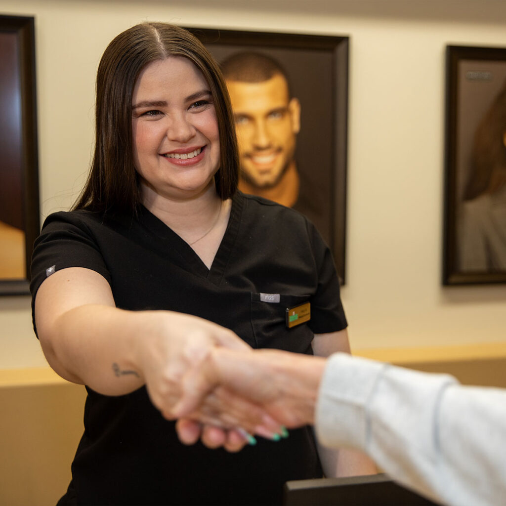 patient being helped at the front desk and getting started for their dental treatment