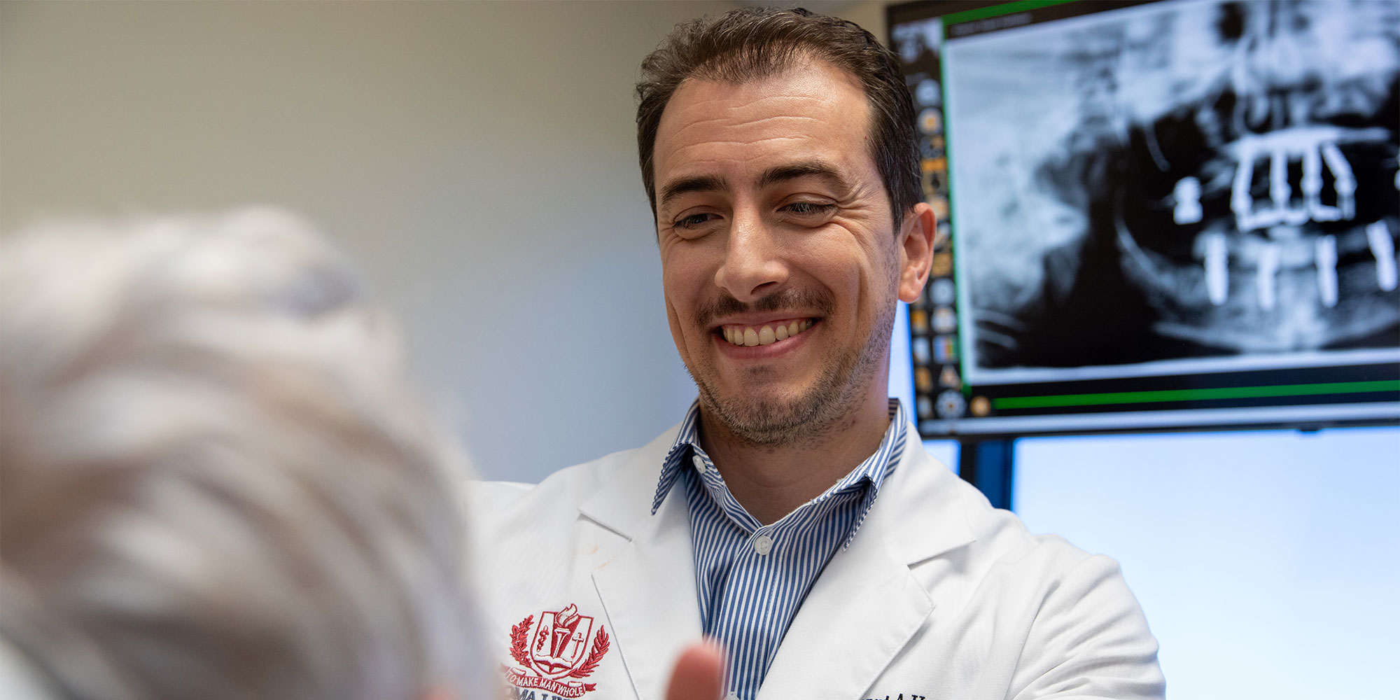 doctor examining dental implant patient