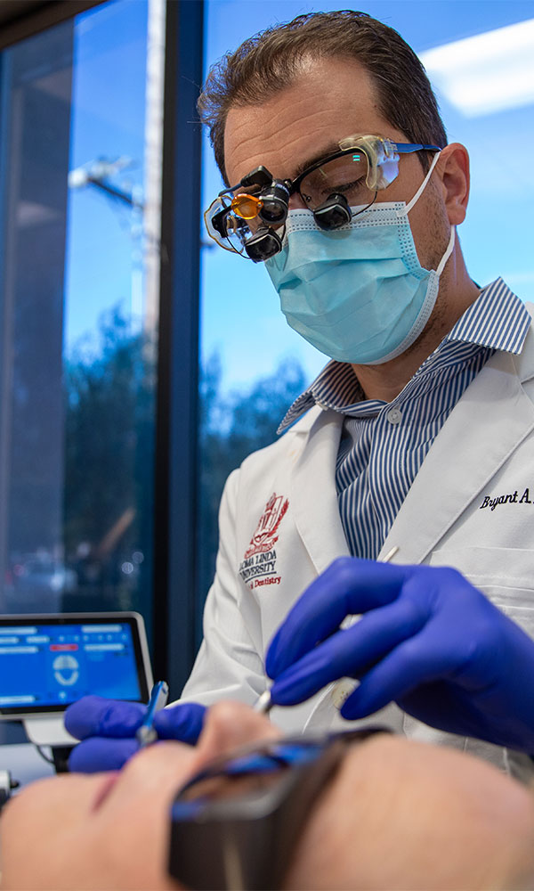 doctor performing oral procedure treatment on patient