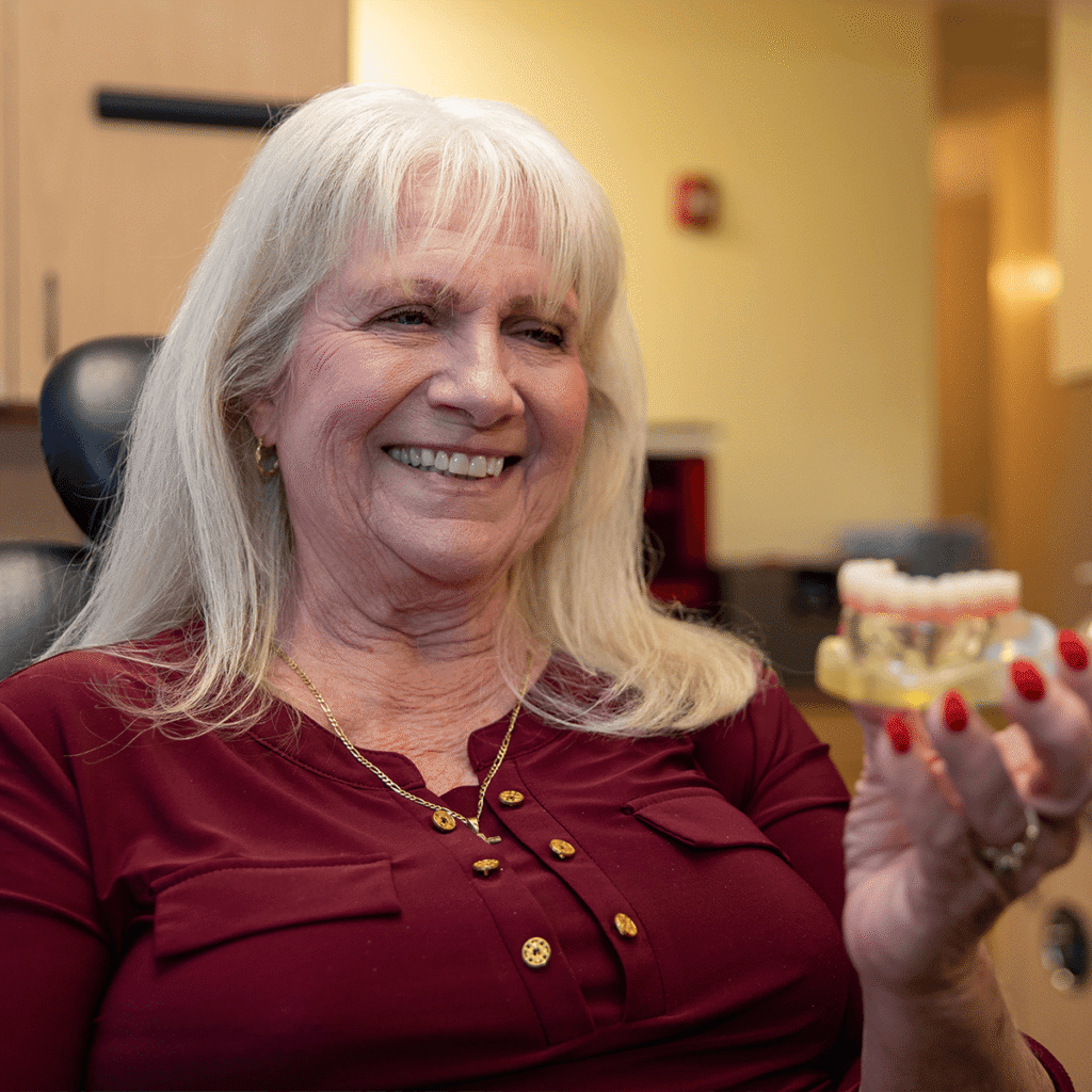 patient looking over a full arch dental implant