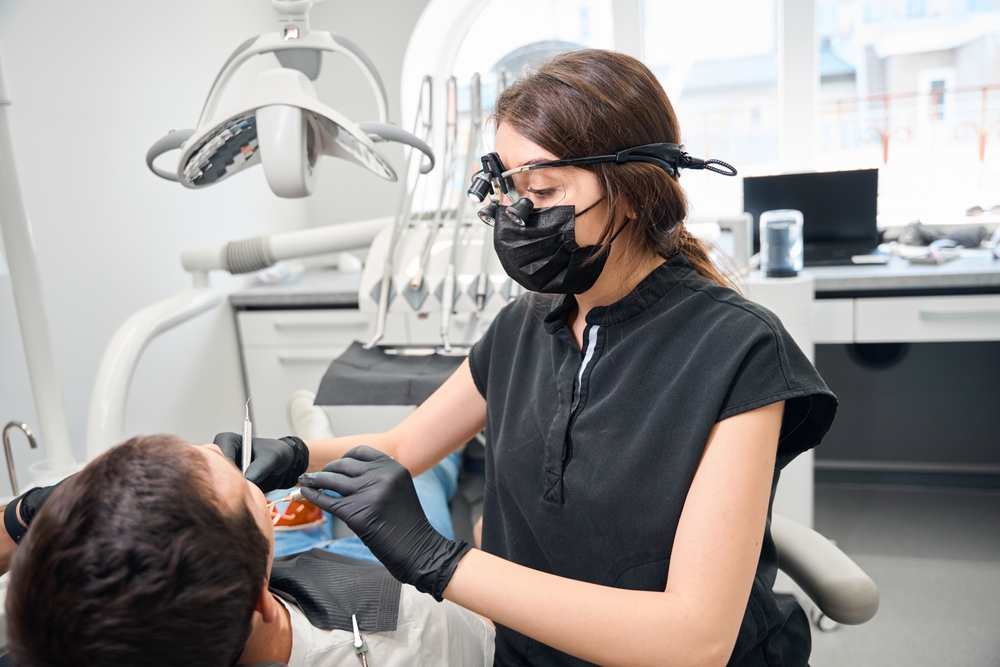 Dr. Tadha consulting with a patient in a modern dental office